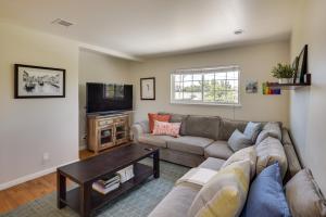 a living room with a couch and a tv at Charming San Jose Home with Covered Patio and Backyard in San Jose