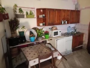 a small kitchen with a table and a microwave at Centar Starog Grada in Kotor