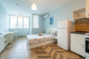 a small bedroom with a bed and a kitchen at Cozy little apartment in Studentski grad in Sofia