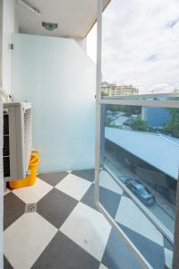 a balcony with a checkered floor and a view at Cozy little apartment in Studentski grad in Sofia