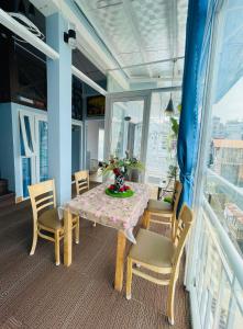 a dining room with a table and chairs at The Blue House in Da Lat