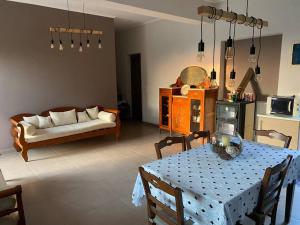 a living room with a table and a couch at Rustic- Chic Villa in a Private Olive Grove - Filiatra in Filiatra