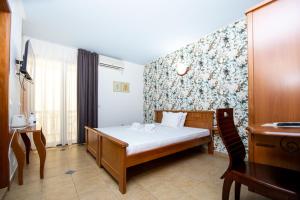 En eller flere senge i et værelse på Tanja Apartments