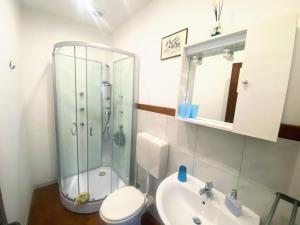 a bathroom with a shower and a toilet and a sink at Teocle Beach rooms in Giardini Naxos