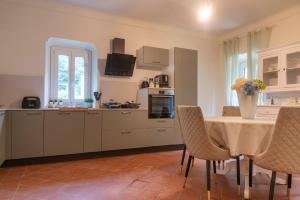 a kitchen with a table and some chairs and a table and a kitchen at Palazzo Branca - Unique experience in Brissago
