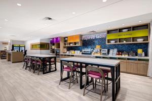 a restaurant with tables and chairs in a cafeteria at Home2 Suites By Hilton Petaluma in Petaluma