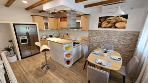 a kitchen with a table and a counter top at Villa Umbra et Sol in Gruda