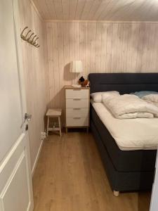 a small bedroom with a bed and a night stand at Holiday home in beautiful Sjusjøen, near Lillehammer in Ringsaker