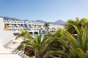 a view of a resort with palm trees and buildings at The Paradise suites by ANNE, Cozy apartment in Adeje in Adeje