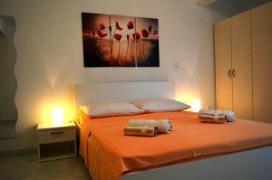 Postel nebo postele na pokoji v ubytování Permarinus Apartments