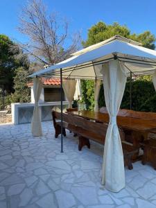 a picnic table under an umbrella on a patio at Apartman Marla in Sevid