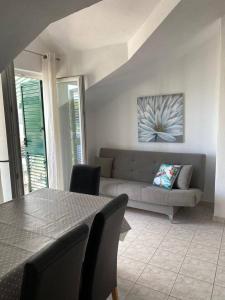 a living room with a couch and a table at Apartman Marla in Sevid