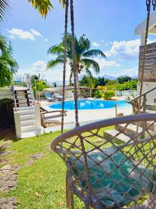 a swing in front of a swimming pool at Ma Vie La in Le Morne