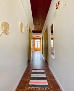 a hallway with a tile floor and white walls at To Petrino in Meyisti