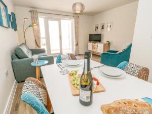 a bottle of wine on a table in a living room at Meadow Bay in Bideford