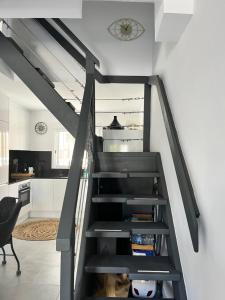 a staircase in a kitchen with a black railing at Prachtig gemoderniseerde woning op 250 meter van het strand in Santa Pola