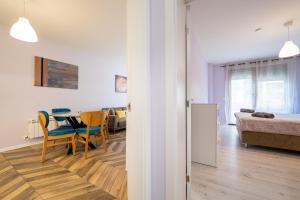 a room with a table and chairs and a bedroom at Sunny Apartment in Studentski grad, behind UNSS in Sofia