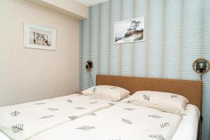 a bedroom with two beds and a window at Feriendomizil Prerow in Prerow