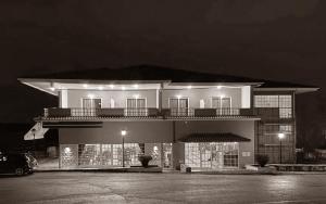 a black and white photo of a building at night at Βαδόκειος ΓΗ in Zítsa