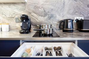 a drawer in a kitchen with utensils in it at Stylish Retreat in Hove