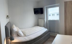 Postel nebo postele na pokoji v ubytování Hotel Paula Norderney