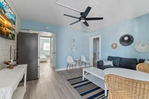 a living room with a couch and a ceiling fan at Harbor Light Family Resort in North Wildwood