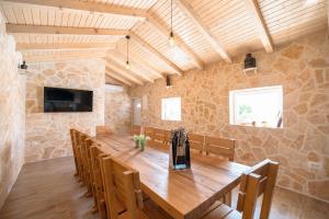 a large dining room with a wooden table and chairs at Villa Matea in Nin
