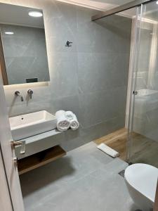 uma casa de banho com um chuveiro, um lavatório e um WC. em Rodanthi 4 Seasons Unique House em Tympáki