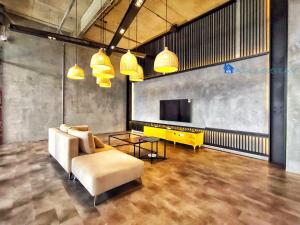 a living room with a couch and a tv at Millerz Square by A Plus Stay in Kuala Lumpur