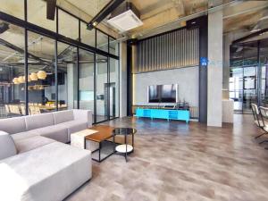 a living room with a couch and a tv at Millerz Square by A Plus Stay in Kuala Lumpur