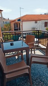 a table and chairs sitting on a balcony at Villa Athina Gia in Sarti