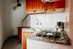 a kitchen with a stove and a counter top at Casa El Guincho, Garachico in El Guincho