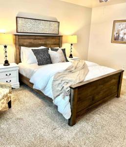 a bedroom with a large bed with white sheets and pillows at 2 Story Meridian Home in Meridian