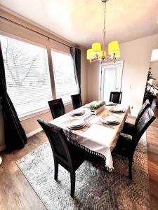 a dining room table with black chairs and a table at 2 Story Meridian Home in Meridian