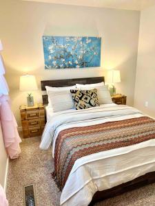 a bedroom with a bed and a painting on the wall at 2 Story Meridian Home in Meridian