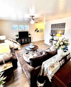 a living room with couches and a table at 2 Story Meridian Home in Meridian