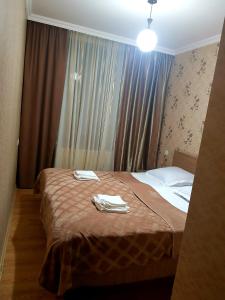 une chambre d'hôtel avec un lit et des serviettes. dans l'établissement Guest House on V. Pshavela 50, à Kazbegi