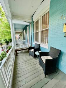 um alpendre com cadeiras e uma casa azul em 3 Level 4 Bedroom Home w/ Parking in Adams Morgan em Washington
