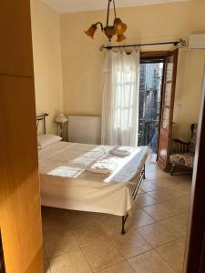 a bedroom with a large bed with a window at Pyrgos in Pyrgi