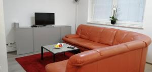 - un salon avec un canapé en cuir et une table dans l'établissement Vacational apartment, à Bottrop