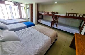 a room with three beds and two bunk beds at Ponta Negra Temporada in Natal