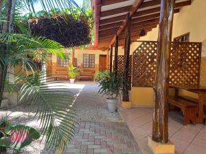 a courtyard of a house with potted plants at Cabinas El Colibri in Carrillo