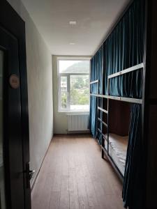a room with bunk beds and a window at ATI MTA - Eco Hostel in Borjomi
