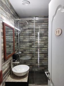 a bathroom with a sink and a shower at ATI MTA - Eco Hostel in Borjomi