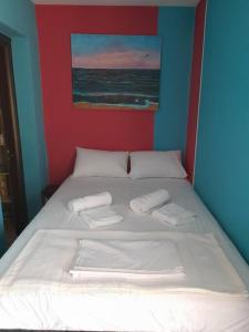a bed with two towels on top of it at villa Narkissos - Καναλάκι - Εξοχική κατοικία in Nárkissos +25 photos