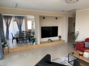 a living room with a large flat screen tv on a wall at Panoramic View Apartment Leonardo in Rab