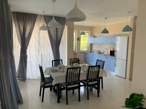 a kitchen and dining room with a table and chairs at Panoramic View Apartment Leonardo in Rab