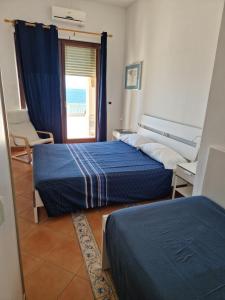 Postel nebo postele na pokoji v ubytování Il paradiso sul mare