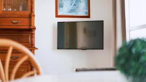 a flat screen tv hanging on a wall at Novo Blue in Chiclana de la Frontera