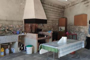 a kitchen with a table in a room at Casa El Calderon in Chella